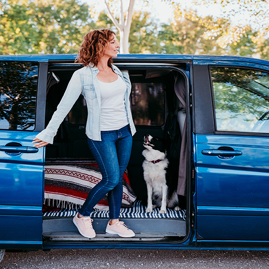woman-and-border-collie-dog-in-a-van-travel-conce woman-and-border-collie-dog-in-a-van-travel-conce